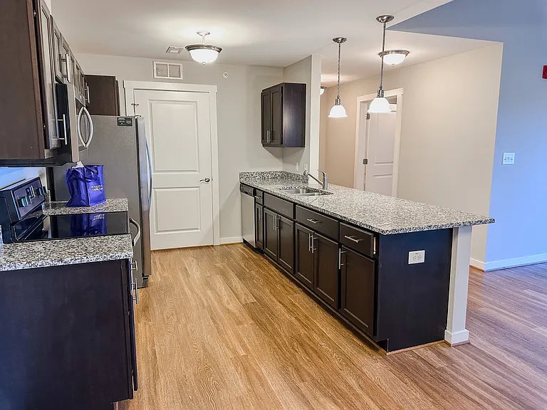 The kitchen features granite countertops and stainless steel appliances.