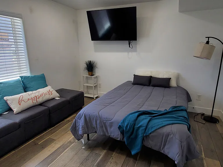 Spacious master bedroom that can easily fit a large bed and additional furniture. Enjoy a comfortable and relaxing personal space. (Furniture shown is not included).