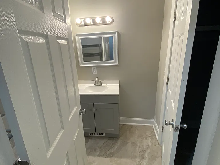 Looking into the bathroom from the hallway.