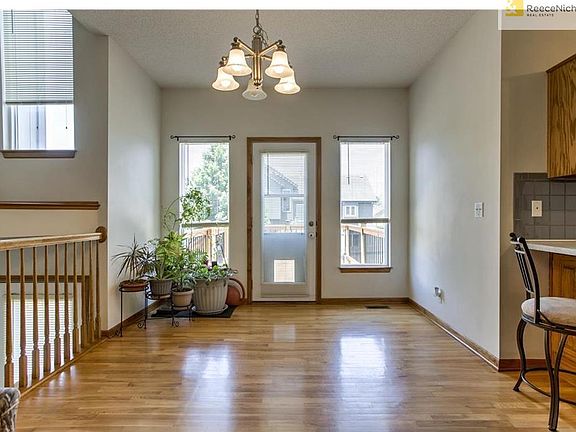 Dining room with wood floor. Lead into dining room from living room and it is a kitchen/ dining room combo. Door leads out to new deck built in 2015.