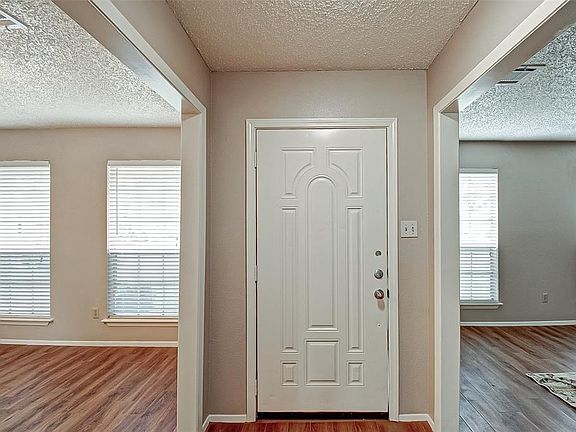 The interior of this home is light and bright and boasts fabulous, wood look, tile flooring.