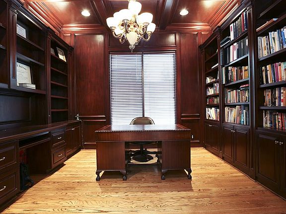 Handsome wood paneled study with built-ins