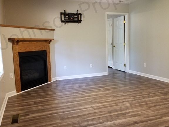 Functional direct vent gas fireplace with remote control start and Oak surround.