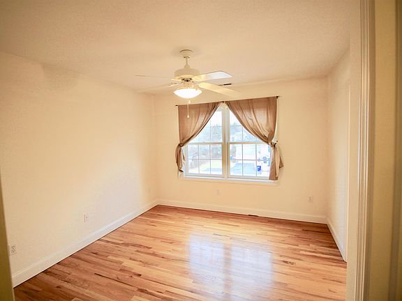 Master bedroom with paddle fan/ walk in closet/full master bath with walk in shower.