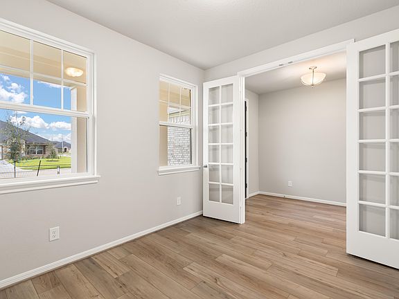 Quietly nestled in the front of the home, the office features French doors, beautiful floors and lar