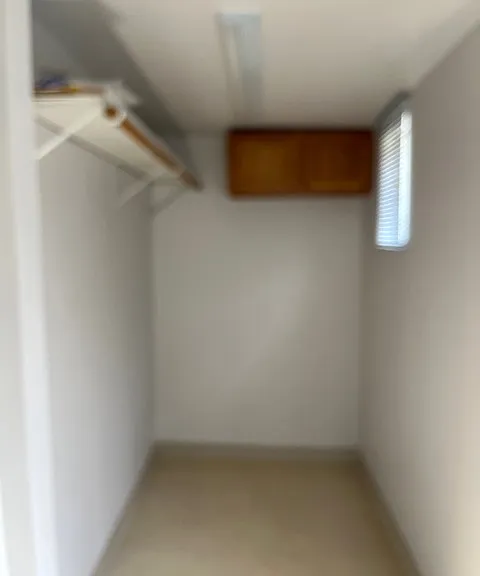 one side of the mud room (which is off the kitchen) with closet rod for coats & jackets. There is a door between this mudroom and the kitchen