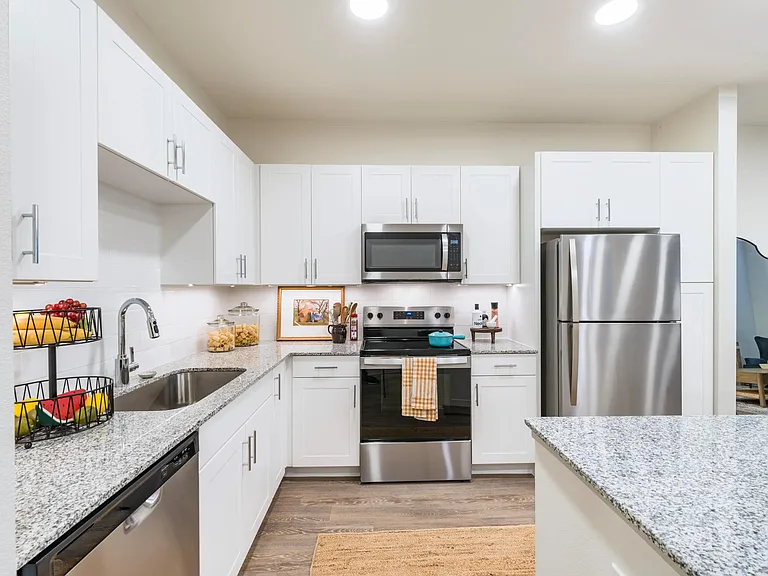 Kitchens with stainless steel appliance package, single-basin sink with pull-down faucet, and stylish tile backsplash.