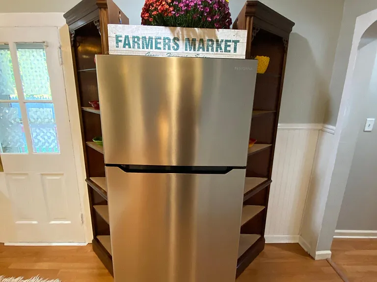The updated lighted Built-in refrigerator storage shelving and energy-efficient stainless refrigerator