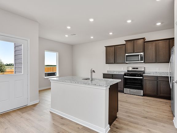 The kitchen has designer wood cabinetry.