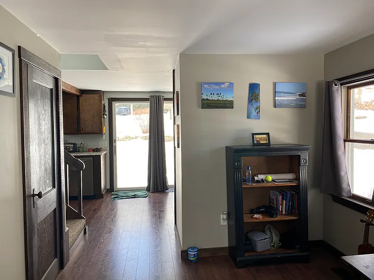 View from living room towards kitchen and sliding glass door to concrete patio.