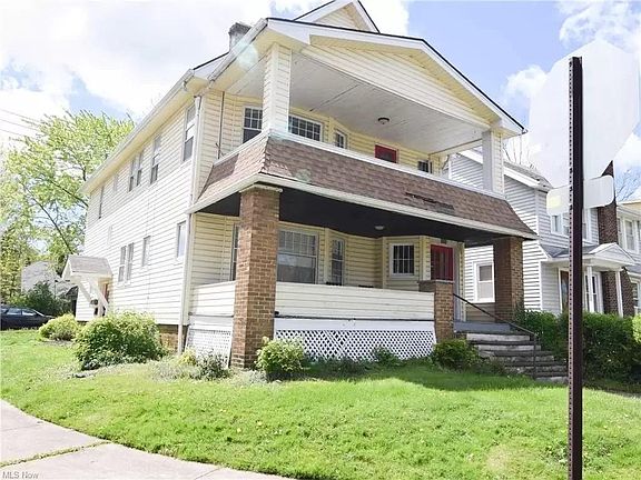 The property offers a front and rear yard, outdoor living, and a dedicated garage parking spot.