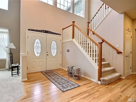 Gorgeous entry & staircase! Extensive refinished real hardwood floors!