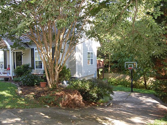 right side view: driveway, garage, double deck and basketball goal