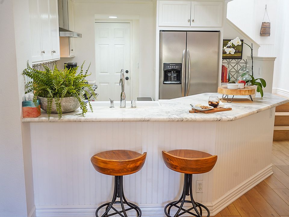 Kitchen with view of stairs to go up to second bedroom & bath. White door 
 leading out to garage. Great for ease of bringing in groceries.s