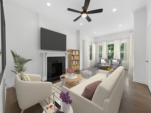 Living area with hardwood floors and decorative fireplace
