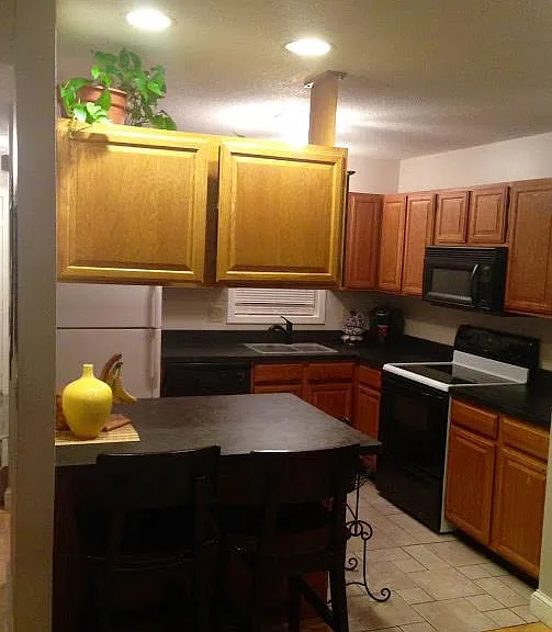Tile floor kitchen with island.