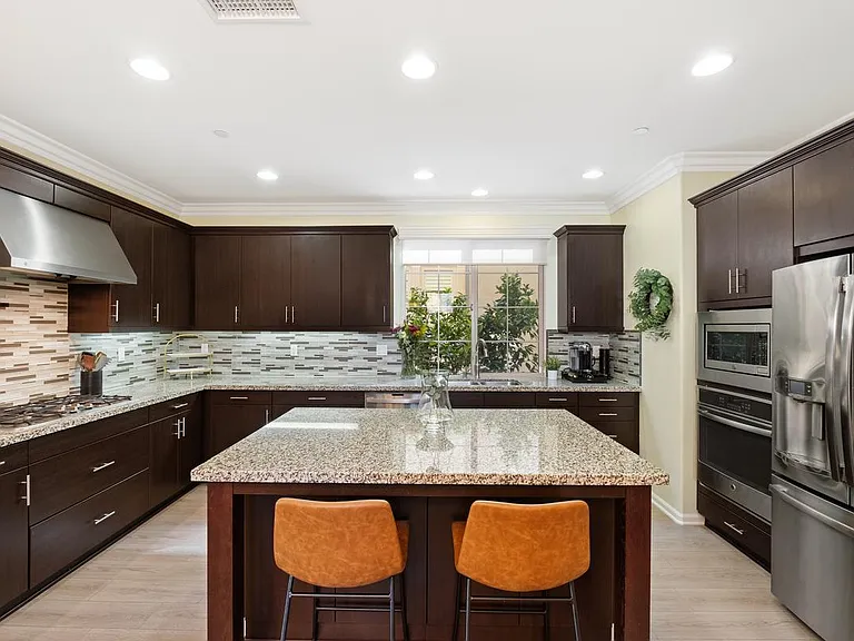 Kitchen has island with seating