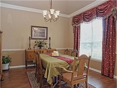 GRAND DINING ROOM with gleaming hand-scraped wood laminate floor