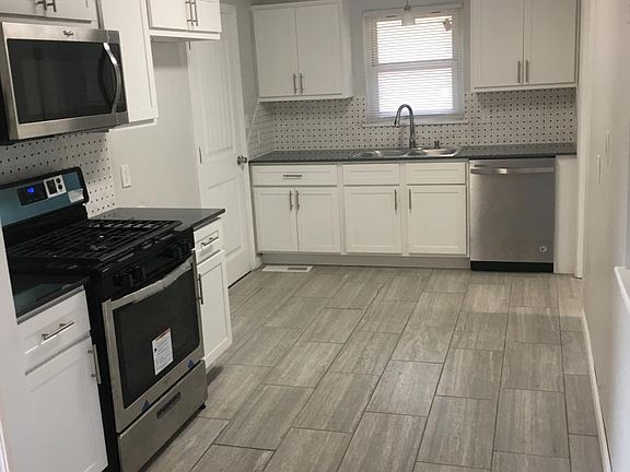 NEW KITCHEN WITH NEW TILE FLOORS AND APPLIANCES