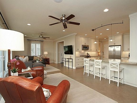 Custom details and designer touches are seen immediately upon entering the home. The spacious open concept, dual ceiling fans, crown molding, recessed lighting, in-ceiling speakers...