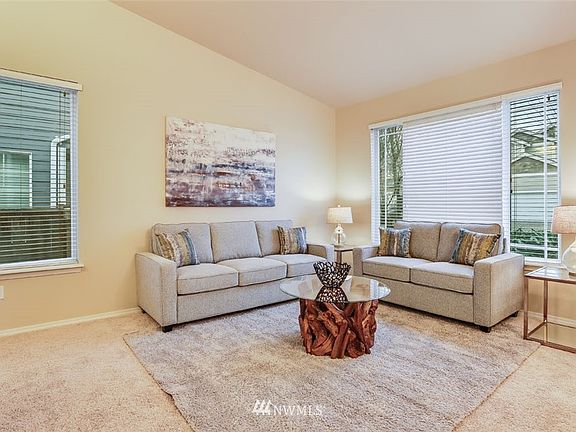 Living room featured vaulted ceilings.