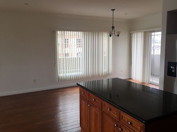 Kitchen island and dining room; door to patio.