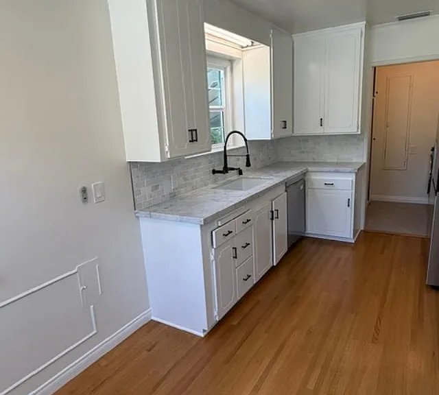 Kitchen is adjacent to laundry room with side door access to driveway.