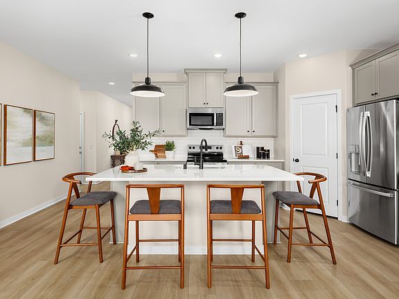 Kitchen with pendant lighting and luxurious wood flooring