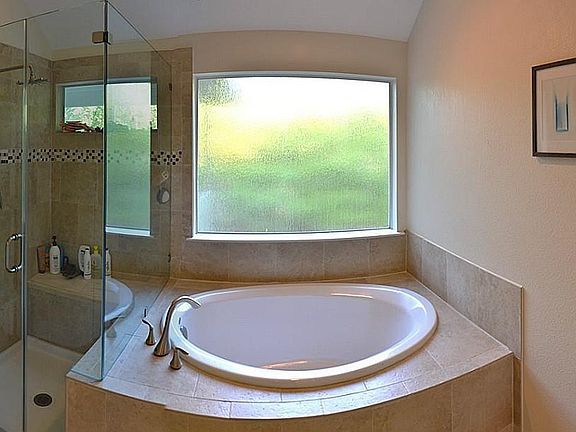 Separate shower and bathtub in Master bathroom.