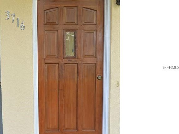 Solid wood, stained front door.  Owner is leaving storm door should buyer want to re-install.