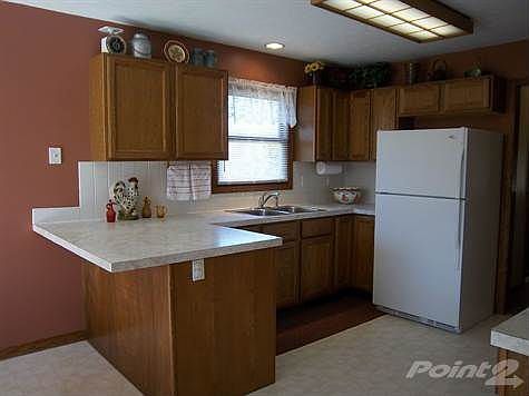 Functional kitchen with snackbar, dishwasher, refrigerator and...