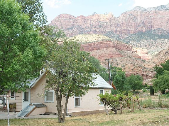 Live in this two bedroom home while you build! Shade and fruit trees, grapes 