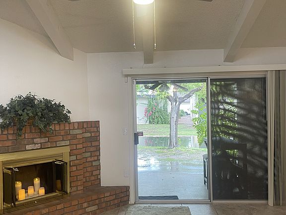 Livingroom with a patio view, and stream behind home.