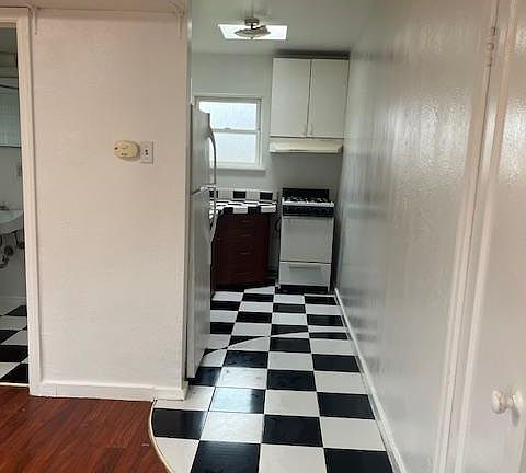 Gas range with refrigerator out of sight to the left