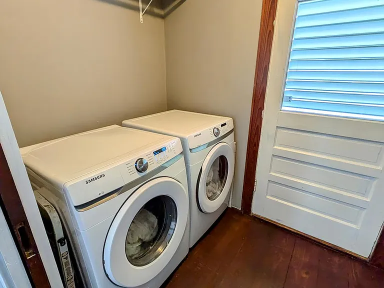 Dedicated laundry/mud room with back yard access. Extra storage area opposite washer and dryer. Washer/dryer not included.