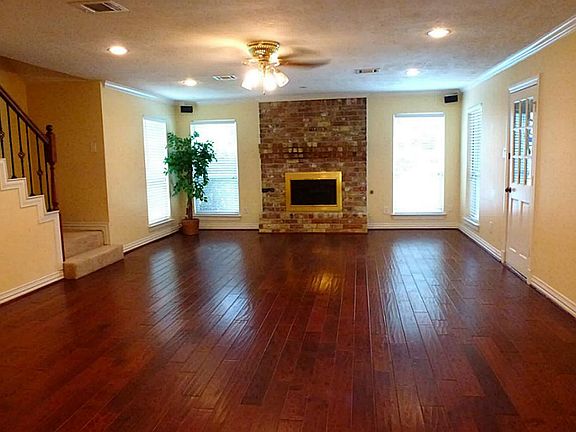 Large living area with hardwood floors and gas log fireplace