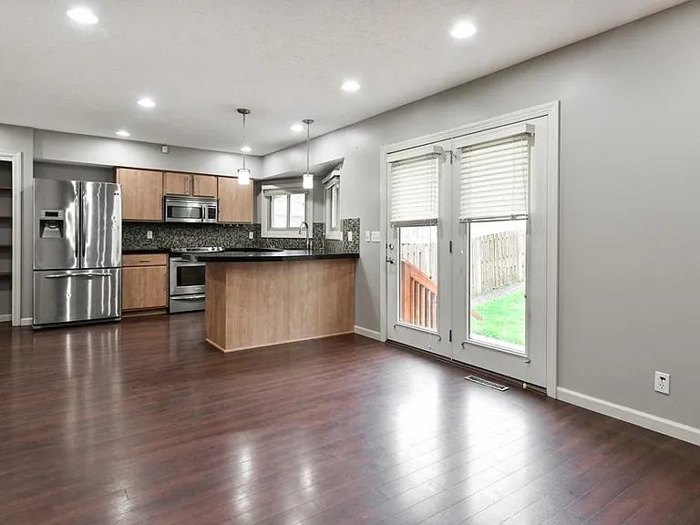 Kitchen and Family Room Areas with WalkOut to Back Patio and Yard