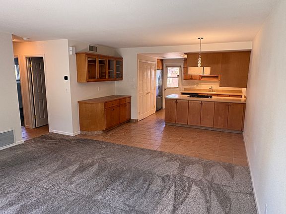 living room looking into dining area and kitchen