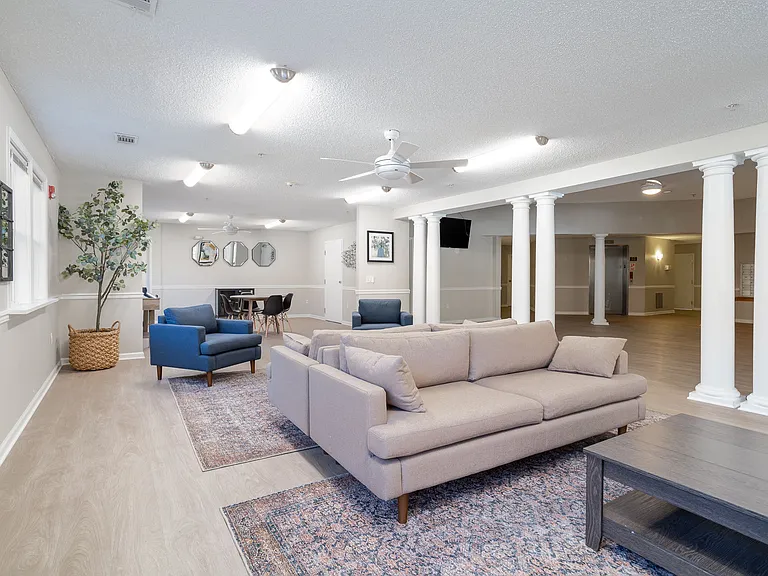 Gather with neighbors in our welcoming lounge featuring couches, chairs, and coffee table seating, professionally operated by Highlands Vista Group.