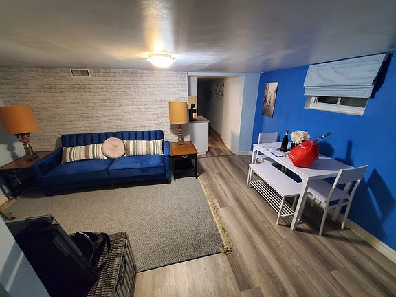 Living room with sofa, workspace table, fridge