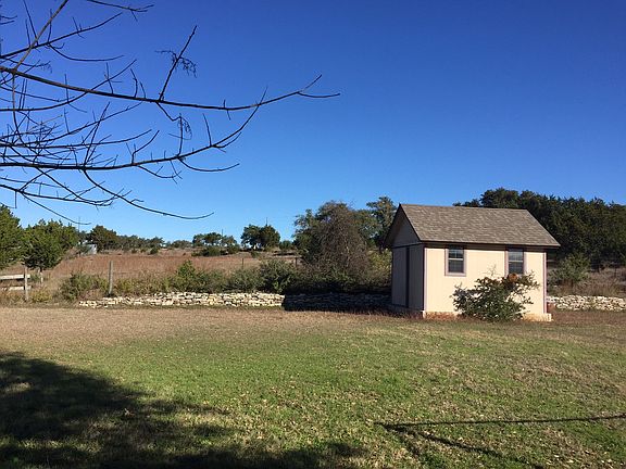 back yard with view of fields and shed
