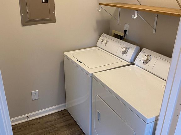 Laundry room with full size washer and dryer plus storage above units and separate linen closet.
