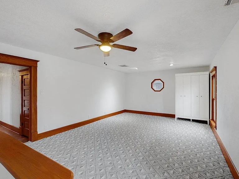 Large 5th bedroom (or upstairs family room) with second staircase leading directly to kitchen for late night snacks.