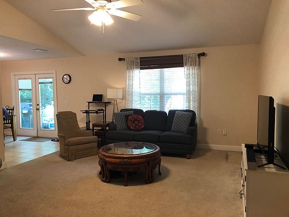 Living area with vaulted ceilings and ceiling fan