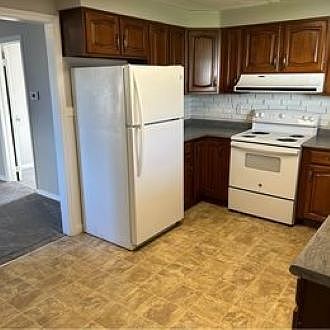Updated kitchen with appliances, including dishwasher and disposal