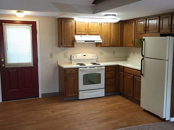view from sitting area into kitchen and back door leading to shared deck