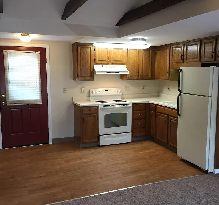 view from sitting area into kitchen and back door leading to shared deck