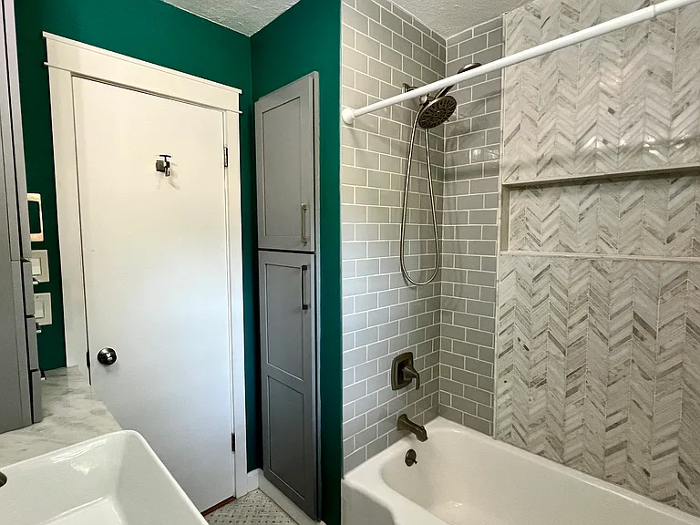 Bathroom
Features: Linen cabinet with the bottom part housing the tankless water heater.
