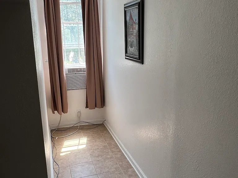 Windows look out over the oak trees and front lawn - sun-blocking drapes