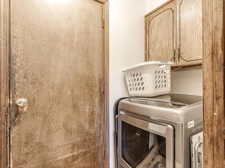 Washer and dryer hookups beside the door that leads to the garage